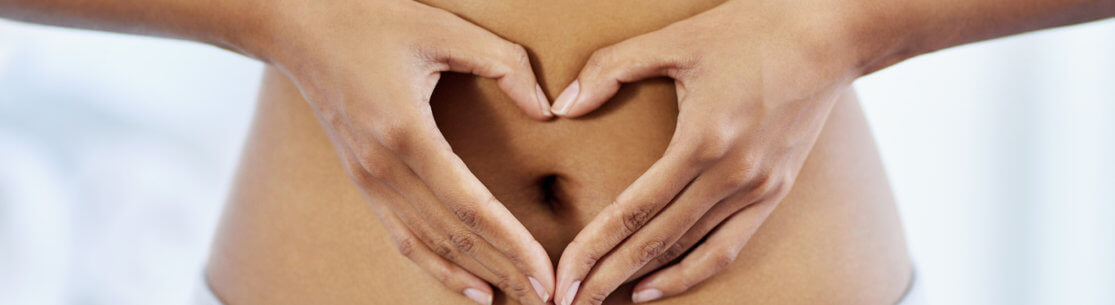 Cropped shot of an unrecognizable woman posing with her hands on her stomach